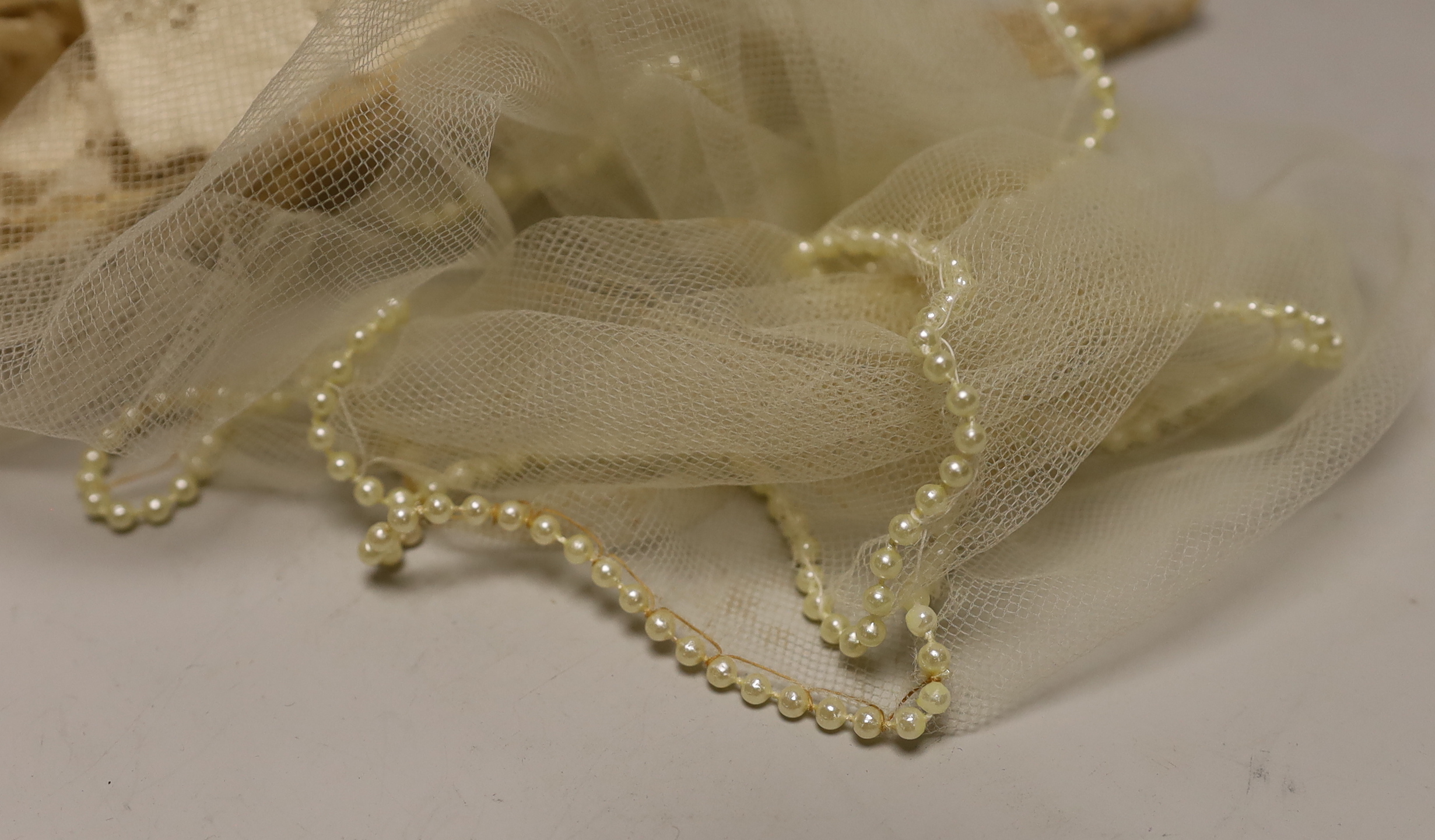A silk Maltese lace trim, mixed lace and a pearl edged veil